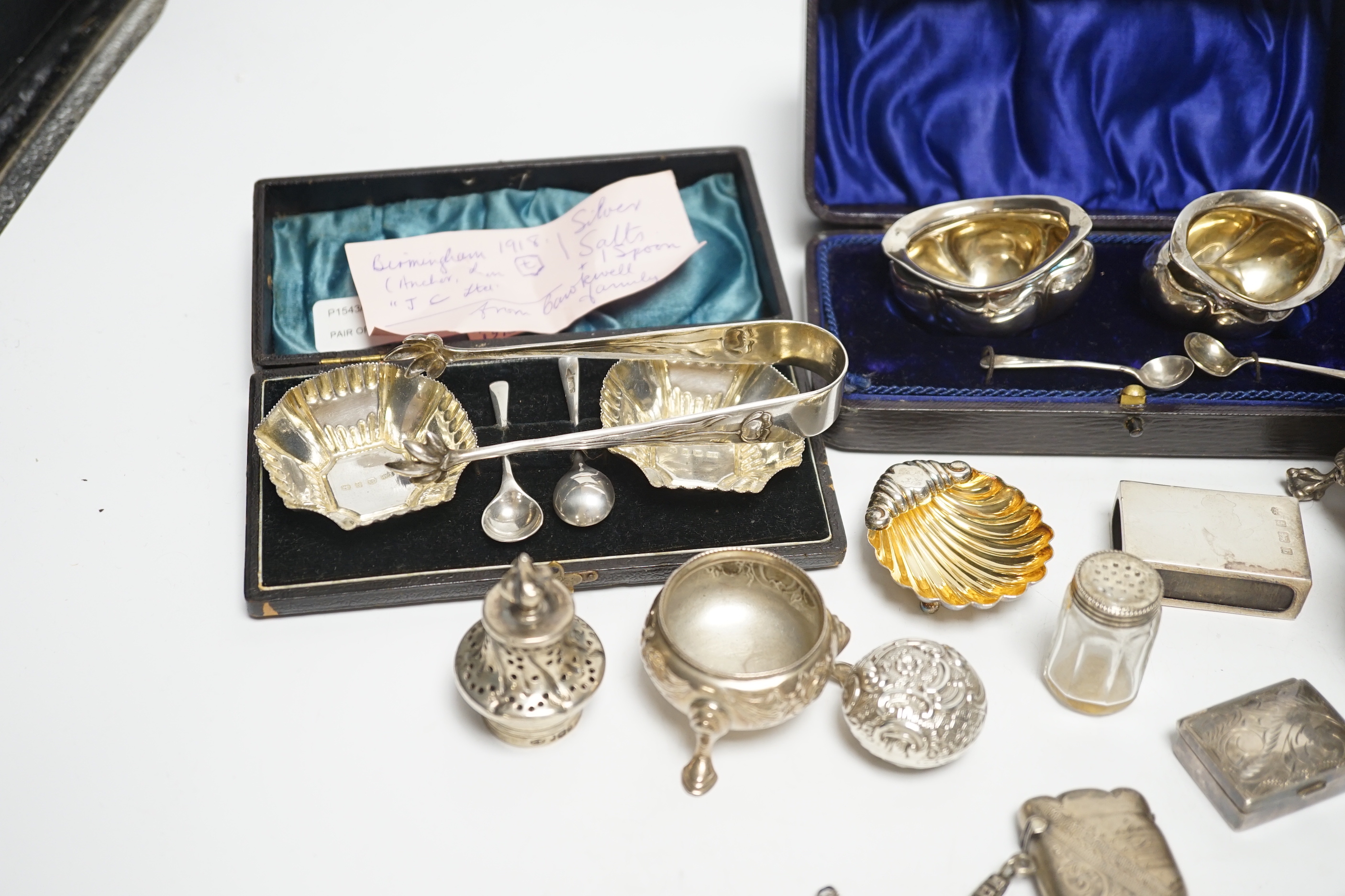 Sundry small silver including a Victorian silver cruet stand, London, 1858 (lacking one bottle), two salts, a vesta case, pill boxes, pair of sugar tongs, two cased pairs of salts with spoons, five mounted glass bottles,